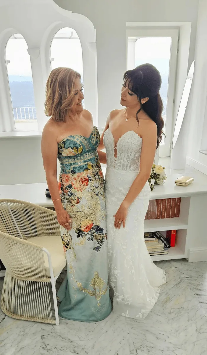 Mother of the bride in a floral brocade gown with her daughter